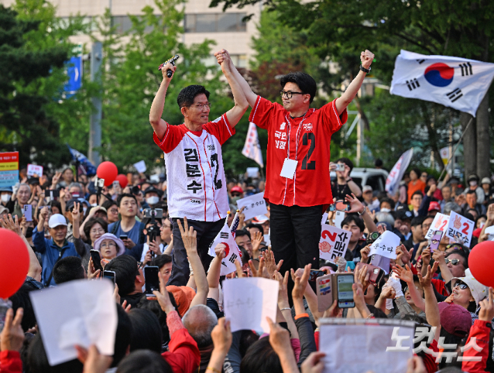 김문수 국민의힘 대선 후보가 26일 서울 도봉구 방학사거리에서 열린 '노원·도봉·강북 집중유세'에서 한동훈 전 대표와 손을 잡고 지지를 호소하고 있다. 황진환 기자