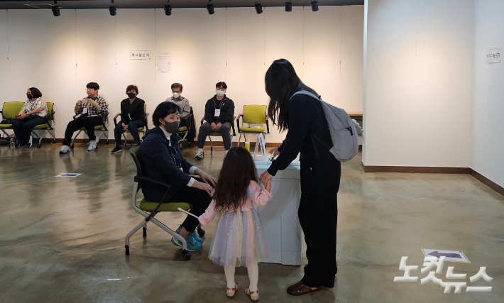 제21대 대통령선거 투표일인 3일 부산 수영구 생활문화센터에 마련된 광안2동 제2투표소에서 한 유권자가 자녀와 함께 소중한 한 표를 행사하고 있다. 김혜민 기자 