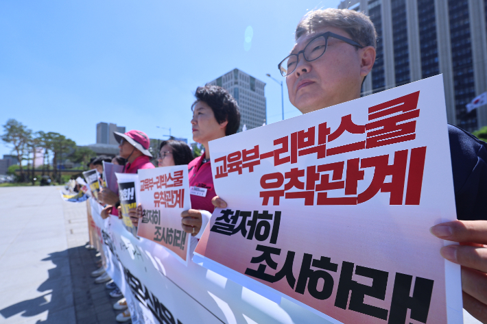 전국교직원노동조합 등 단체 회원들이 지난 4일 서울 종로구 정부서울청사 앞에서 열린 '극우세력의 학교 침투 발본색원 공동 기자회견'에서 팻말을 들고 있다. 연합뉴스