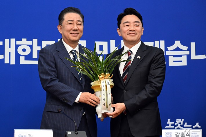 강훈식 대통령 비서실장이 17일 서울 여의도 국회에서 더불어민주당을 찾아 김병기 당대표 직무대행 겸 원내대표에게 이재명 대통령의 축하 난을 전달하고 있다.