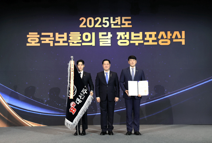  대선주조 최홍성 대표(오른쪽)가 이희완 국가보훈부 차관(가운데)과 기념 촬영을 하고 있다. 대선주조 제공