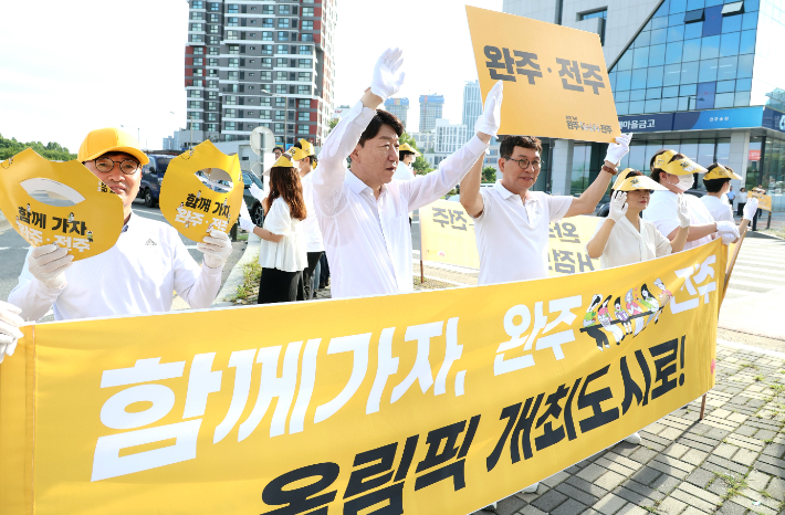 우범기 전주시장을 비롯한 시청 공무원과 민간 단체 회원들이 완주와 전주 접경지역에서 통합 당위성을 알리는 출근길 캠페인을 하고 있다. 전주시 제공