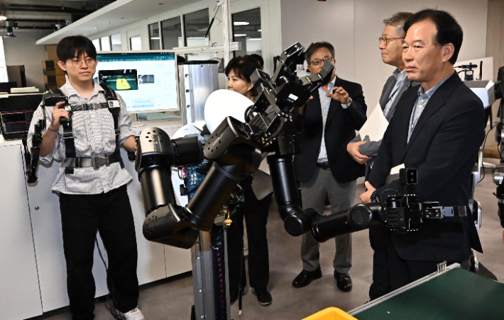 정태호 국정기획위원회 경제1분과장과 기획위원, 전문위원들이 7일 서울 관악구 서울대학교 해동첨단공학관에서 열린 국정위 '기술과 아이디어로 혁신하는 우리곁의 AI 클러스터' 현장방문 행사에서 원격조종을 통한 데이터수집 및 모방학습 추론 시연을 살펴보고 있다. 연합뉴스