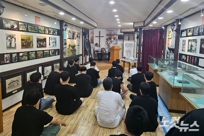 평양장대현교회를 재현해놓은 한국기독교역사박물관의 'ㄱ자 예배당'에서 예배를 드리고 있는 순례단.