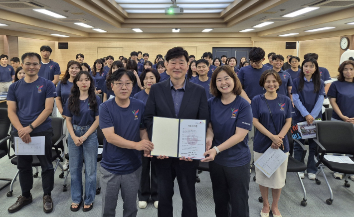 2025 전주드론축구월드컵 대회 전반을 지원하는 공모원 서포터즈 '드론지기' 발대식이 11일 전주시청에서 열렸다. 윤동욱 전주시 부시장(가운데)과 드론지기들이 대표 선서문을 들고 기텸 촬영을 하고 있다. 전주시 제공