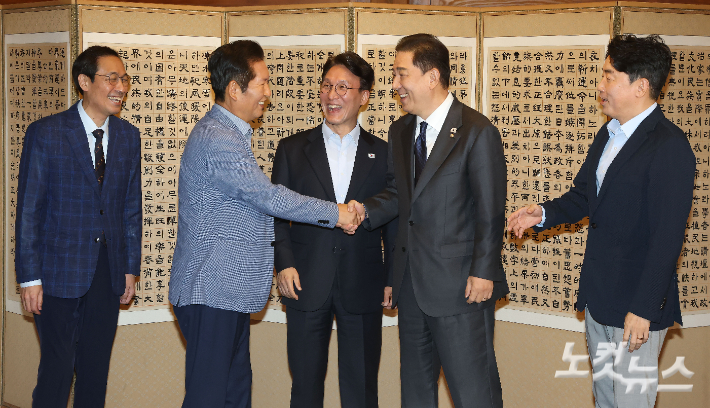 더불어민주당 정청래 대표와 김병기 원내대표가 14일 오후 서울 종로구 삼청동 총리 공관에서 열린 당정대 고위급 만찬회동에 참석해 기념촬영에 앞서 악수하고 있다.  왼쪽부터 우상호 정무수석, 정 대표, 김민석 국무총리,  김 원내대표, 강훈식 대통령 비서실장. 황진환 기자