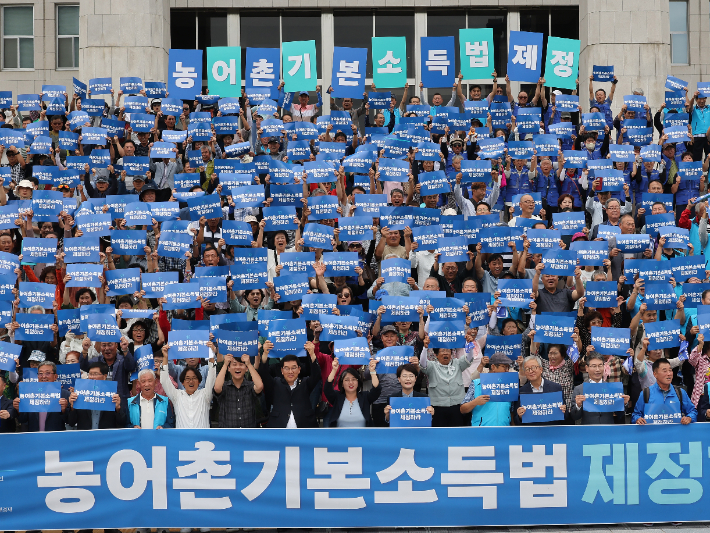 12일 서울 여의도 국회 본청 앞 계단에서 열린 농어촌기본소득법 제정 촉구 기자회견에서 참가자들이 구호를 외치고 있다. 연합뉴스