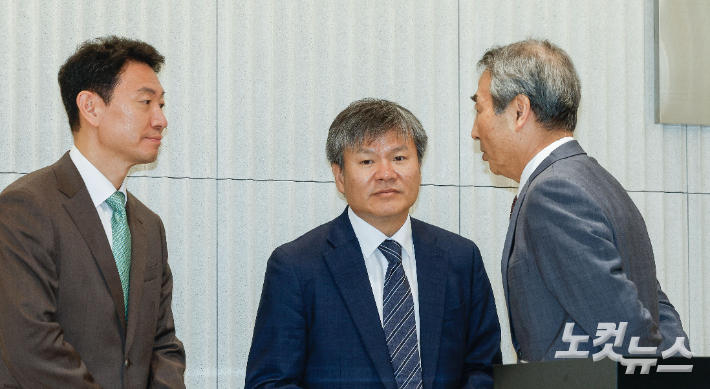 윤석열 전 대통령의 부인 김건희 씨 의혹 관련 사건을 맡은 민중기 특별검사(오른쪽)가 지난 7월 2일 서울 종로구 KT광화문빌딩 웨스트에 마련된 특검 사무실에서 열린 현판 제막식에서 박상진(왼쪽), 문홍주 특검보와 대화를 나누고 있다. 박종민 기자