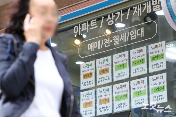 정부가 전날 발표한 '10·15 부동산 대책'으로 주택시장이 충격에 빠진 가운데 16일 오후 서울 성동구의 한 공인중개사무소 앞에서 직원이 매물 안내문을 떼고 있다. 매도자들이 많았다.