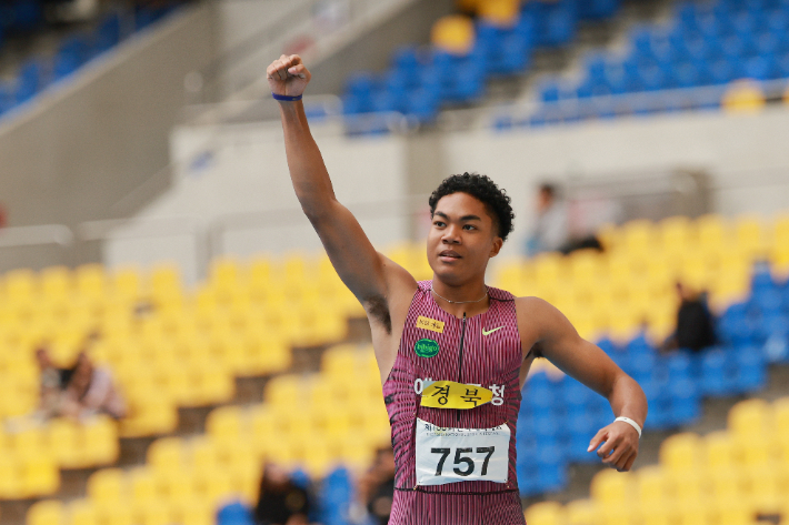 지난 19일 부산 아시아드주경기장에서 열린 제106회 전국체육대회 육상 남자 100m 결승에서 우승한 나마디 조엘진(예천군청)이 기록을 확인한 뒤 손을 들어올려 보이고 있다. 연합뉴스