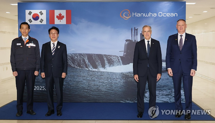 (거제=연합뉴스) 이정훈 기자 = 김민석 국무총리와 마크 카니 캐나다 총리가 30일 경남 거제 한화오션 거제조선소 내 신뢰관 포토월 앞에서 기념촬영을 하고 있다.        왼쪽부터 김동관 한화그룹 부회장, 김 총리, 카니 총리, 데이비드 맥귄티 캐나다 국방장관. 2025.10.30 uwg806@yna.co.kr 연합뉴스