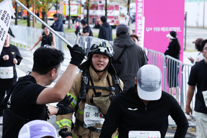 LG유플러스는 지난 2일 소방청과 함께 순직소방관 추모 마라톤 '119메모리얼런'을 성황리에 마쳤다. 119메모리얼런 대회 참가자들이 전력 질주하고 있는 모습과 실제 소방복을 입고 대회에 나선 현직 소방관들의 모습. LG유플러스 제공