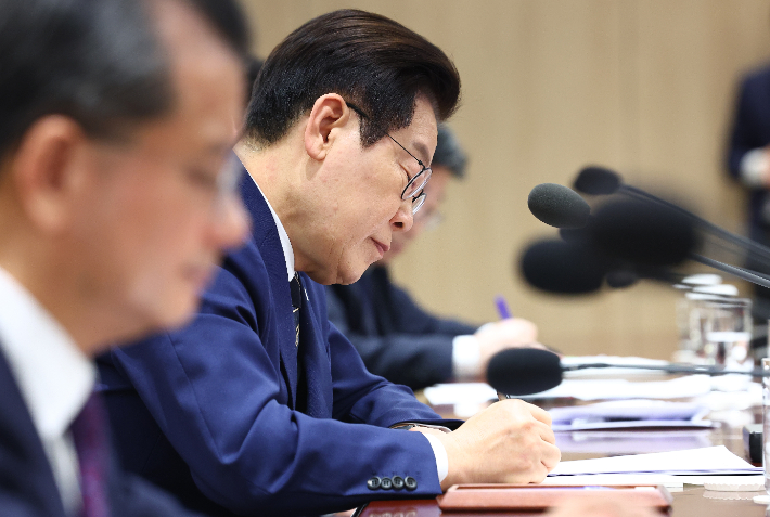 이재명 대통령이 16일 용산 대통령실에서 열린 한미 관세협상 후속 민관 합동회의에서 참석자 발언을 메모하고 있다. 연합뉴스