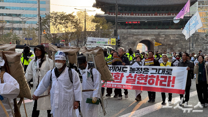 22일 서울 숭례문 앞에서 열린 전국농민대회에서 참가자들이 행진하고 있다. 김수진 기자