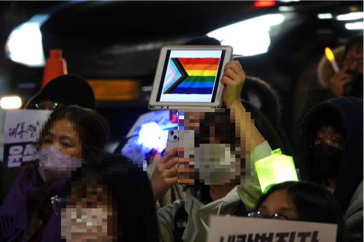 탄핵을 촉구하며 개헌을 외치는 집회에서 한 청소년이 무지개 깃발을 통해 강단의 발언자에 연대 의사를 표하고 있다. 구파란 평화와인권연대 상임활동가 제공