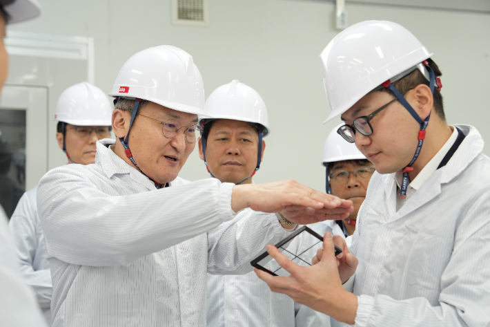 이석희 SK온 사장(왼쪽에서 두 번째)이 5일 대전 대덕구 스탠다드에너지 생산동에서 김부기 스탠다드에너지 대표(오른쪽)로부터 바나듐이온배터리에 대한 설명을 듣고 있다. SK온 제공