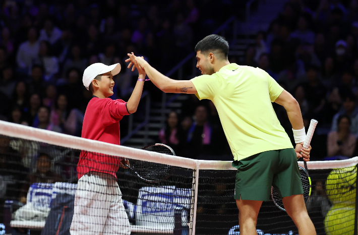 10일 인천 인스파이어 아레나에서 열린 현대카드 슈퍼매치14. 스페인 카를로스 알카라스가 어린이 팬과 경기를 펼친 뒤 인사하고 있다. 이탈리아 시너가 경기 도중 팬 서비스 차원에서 관중석의 어린이와 잠시 교체해 경기를 진행했다. 연합뉴스