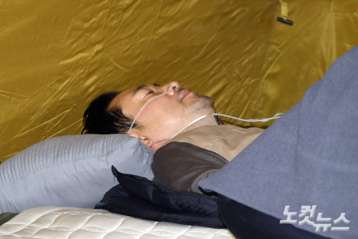 단식 7일차인 국민의힘 장동혁 대표가 21일 오후 서울 여의도 국회 로텐더홀 농성장에서 누워있다. 윤창원 기자