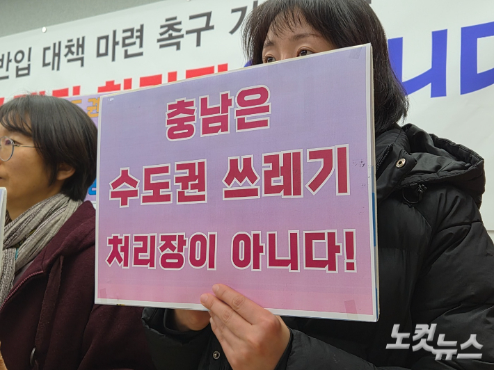 27일 충남도청 브리핑룸에서 열린 기자회견에서 한 참석자가 '충남은 수도권 쓰레기 처리장이 아니다!'라고 적힌 손피켓을 들고 있다. 김정남 기자