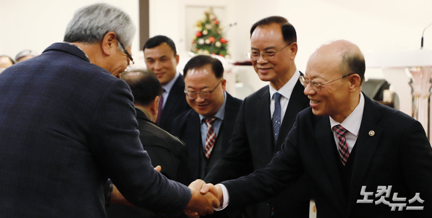 한상인 목사(앞)와 김윤철 목사(뒤) 등 임원들이 회원들과 악수례를 하고 있다. 한세민 기자