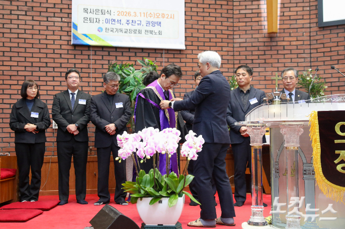 박기주 직전 노회장이 신임 노회장으로 선출된 양진규 목사에게 노회장 스톨을 전달하고 있다. 최화랑 기자