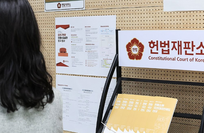 '최종심'인 대법원의 판결을 헌법재판소에서 다툴 수 있는 내용을 포함한 '사법개혁 3법'이 공표된 첫날인 12일 서울 헌법재판소 민원실에서 관계자들이 안내문 비치 등을 점검하고 있다. 연합뉴스