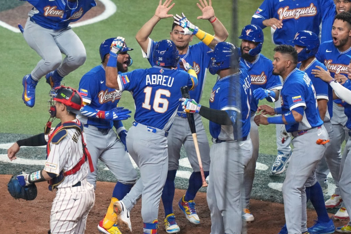 베네수엘라 아브레유(16번)가 15일(한국 시각) 일본과 WBC 8강전에서 역전 결승 3점포를 터뜨린 뒤 동료들의 축하를 받고 있다. 연합뉴스 