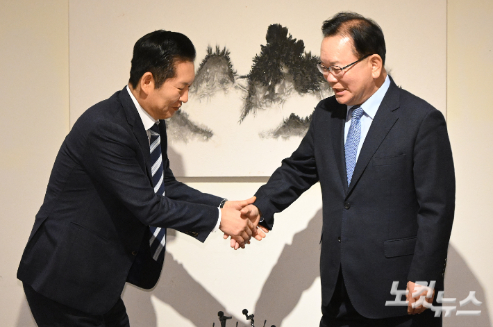 정청래 더불어민주당 대표와 김부겸 전 국무총리가 26일 서울 중구 달개비에서 회동 전 손을 맞잡고 있다. 국회사진기자단