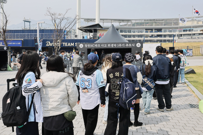 29일 10시30분 창원NC파크 화합의 탑 인근에서 '창원NC파크 사고 희생자 1주기 추모식'에서 야구팬들이 고인에게 추모하기 위해 줄을 서고 기다리고 있다. 창원시 제공 