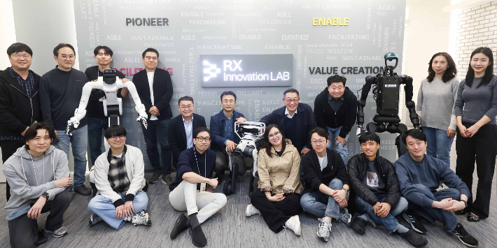 LG CNS RX 이노베이션 랩 출범식에서 임직원들이 기념사진을 촬영하고 있다. LG CNS CEO 현신균 사장(윗줄 오른쪽 네 번째), 스마트물류&시티사업부장 이준호 전무(윗줄 왼쪽 다섯 번째), CTO 박상엽 상무(윗줄 오른쪽 세 번째), 스마트물류센터/로봇사업담당 명창국 상무(윗줄 왼쪽 네 번째). LG CNS 제공
