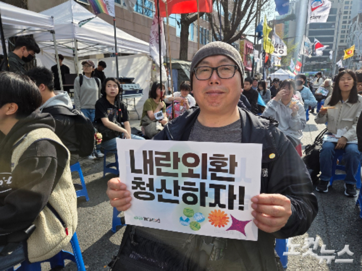 4일 내란청산·사회대개혁 비상행동 주최로 열린 '4·4 내란청산 사회대개혁 주권자 승리의 날 시민행동'에 참여한 시민이 손팻말을 들고 있는 모습. 민소운 기자
