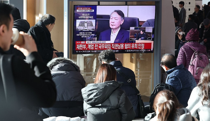 서울역 대합실에서 시민들이 고위공직자범죄수사처(공수처) 체포 방해 등 혐의로 기소된 윤석열 전 대통령에 대한 1심 선고 공판 생중계를 보고 있다. 연합뉴스