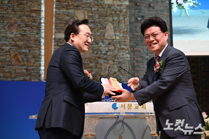 청주지방회장 조장현 목사가 박명룡 목사에게 위임패를 전달하고 있다. 서문교회 제공