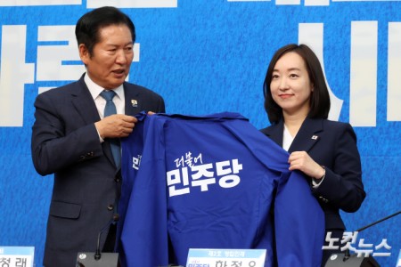 더불어민주당 정청래 대표가 29일 서울 여의도 국회에서 열린 2차 인재영입식에서 전은수 전 청와대 대변인에게 당 점퍼를 전달하고 있다.