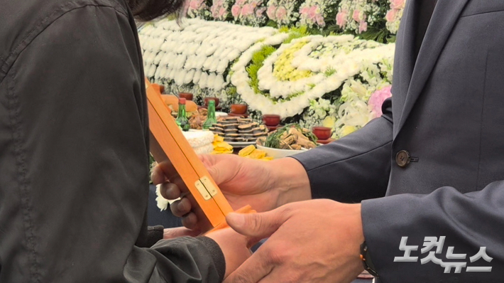 추모식을 마치고 고인의 위패가 유가족에게 전해지고 있다. 김정남 기자