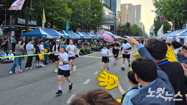 16일 오후 5시 40분쯤 광주 동구 금남로에서 결승선을 코앞에 앞둔 'RUN 5·18' 참가자들을 시민들이 응원하고 있다. 한아름 기자