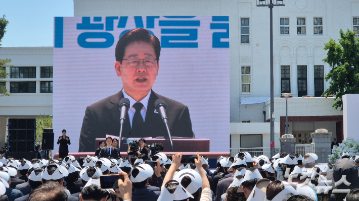 이재명 대통령이 18일 오전 광주 5·18 민주광장에서 열린 제46주년 5·18 민주화운동 기념식에서 기념사를 하자 참석한 시민들이 사진을 찍고 있다. 한아름 기자