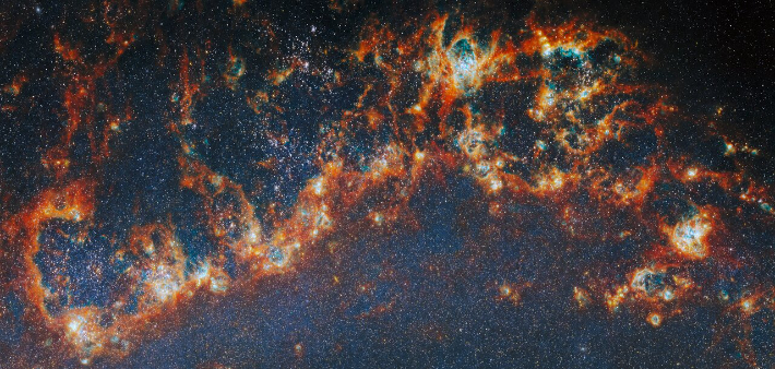 소용돌이 은하 속 나선팔 이미지 모습. ESA/Webb, NASA & CSA, 안젤라 아다모와 알렉스 페드리니(스톡홀름 대학교) and the FEAST JWST team