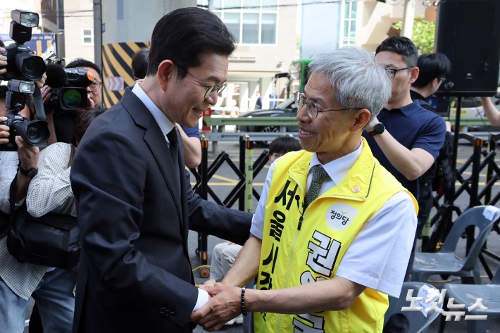 더불어민주당 정원오 서울시장 후보와 정의당 권영국 서울시장 후보가 22일 서울 광진구 지하철 2호선 구의역에서 열린 구의역 참사 10주기 추모문화제에 참석하며 인사를 하고 있다.