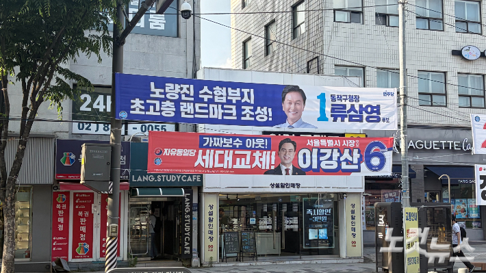 서울 동작구에 걸린 선거 현수막이 상점의 간판을 가리고 있다. 박인 기자
