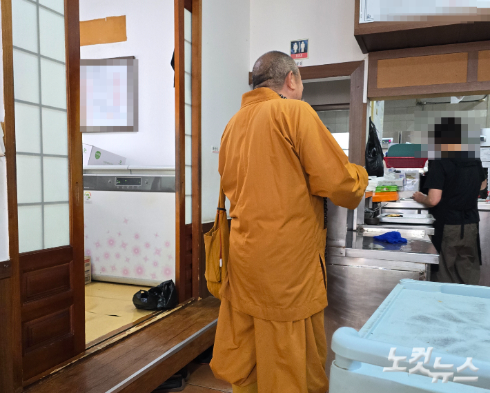 지난 22일 오후 2시쯤 제주시 노형동의 한 식당에서 남방불교식 승려복 차림의 남성이 탁발을 요구하고 있다. 이창준 기자