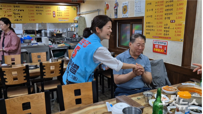26일 저녁 송천동 상가 인사를 돌던 중 최한별 후보를 응원하는 시민과 최 후보가 함께 웃고 있다. 심동훈 기자