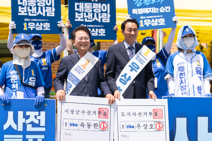 더불어민주당 우상호 강원특별자치도지사 후보와 육동한 춘천시장 후보가 28일 오후 춘천YWCA 앞마당에서 선거운동원들과 함께 대형 모의투표용지를 들고 사전투표 참여를 호소하고 있다.   육동한 춘천시장 후보 제공