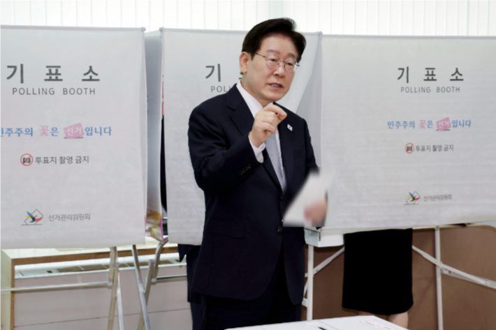 이재명 대통령이 제9회 전국동시지방선거 사전투표 첫날인 지난 29일 서울 종로구 삼청동 주민센터에서 사전 투표 중 기표 도장 관련 문의를 하는 모습. 연합뉴스