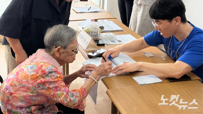 김정자 어르신이 3일 광주 동구 계림1동 제2투표소에서 선거인명부에 서명하고 있다. 김한영 기자