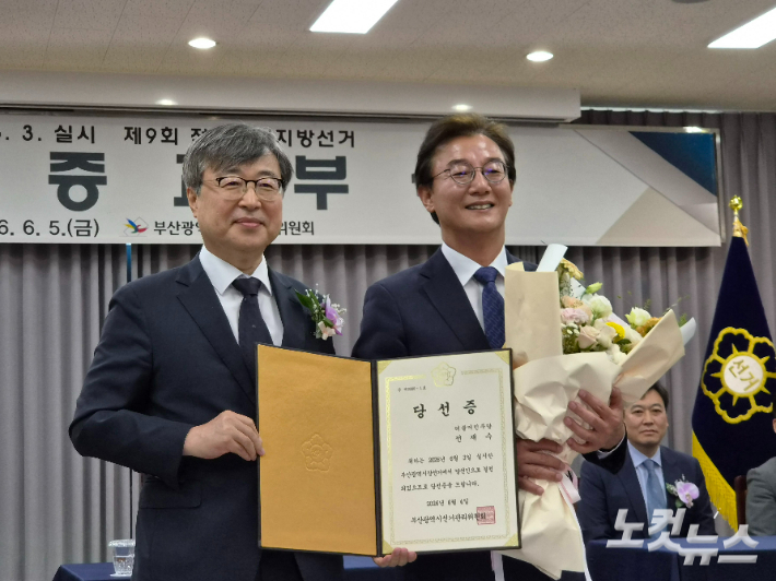 지난 5일 부산 연제구 부산시선거관리위원회에서 열린 제9회 전국동시지방선거 당선증 교부식에 참석한 전재수 부산시장 당선인이 당선증을 받고 기념 사진을 찍고 있다. 정혜린 기자