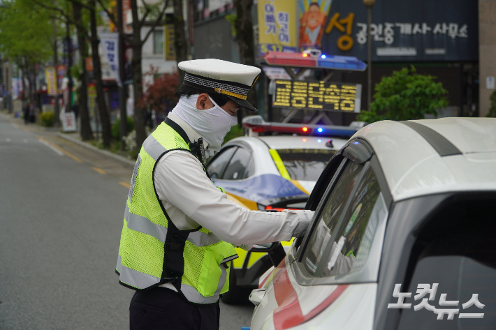 지난 4월 20일 전북 전주시 덕진구 덕진광장에서 경찰이 우회전 일시정지를 하지 않아 적발된 차량을 단속하고 있다. 심동훈 기자