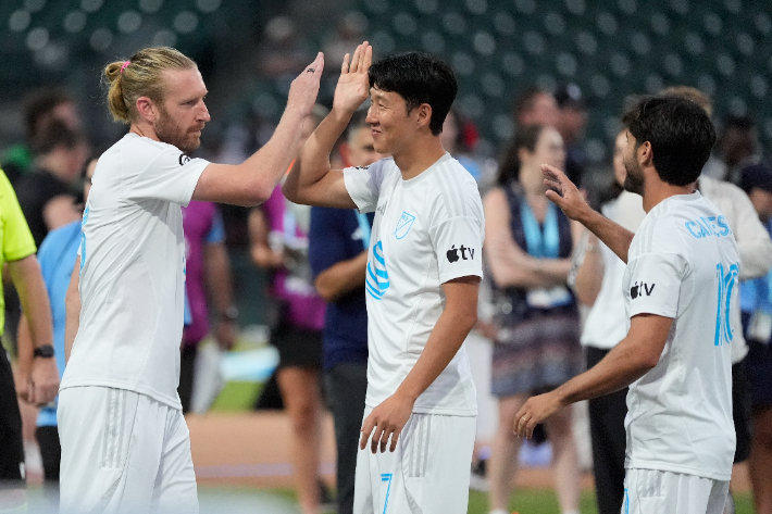 MLS 올스타팀 동료 팀 림(왼쪽)과 하이 파이브 하는 손흥민(사진 가운데). 연합뉴스