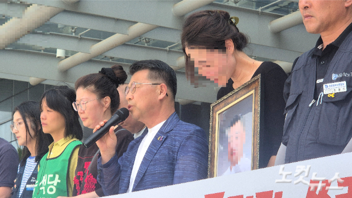 14일 오전 광주지방고용노동청 앞에서 열린 기자회견에서 숨진 노동자 A씨의 아내가 남편의 영정사진을 들고 흐느끼고 있다. 한아름 기자