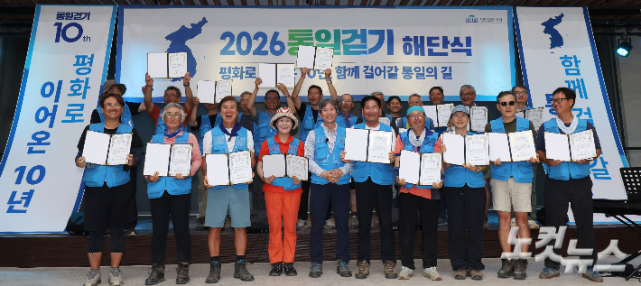 14일 경기 파주 평화누리 DMZ생태관지원센터에서 열린 '2026 통일걷기 해단식' 에서 더불어민주당 이인영 의원이 참가자들에게 완주증을 수여한 뒤 기념촬영 하고 있다. 파주=황진환 기자